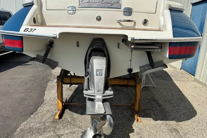Slide: The Image of 2007 Chris-Craft Corsair 25 boat stern view with outboard motor and trim tabs. - 10