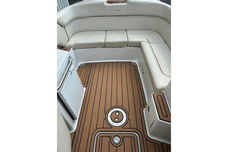 Slide: The Image of 2007 Chris-Craft Corsair 25 interior with teak flooring and cream seating. - 14