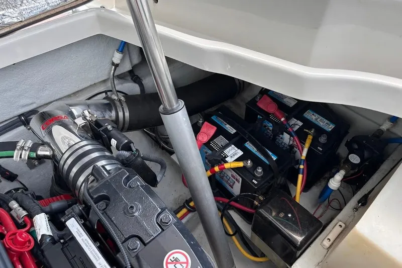 Slide: The Image of Engine compartment of a 2007 Chris-Craft Corsair 25, showing batteries and exhaust system. - 19