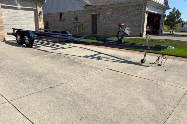 Slide: The Image of Boat trailer for 2007 Chris-Craft Corsair 25 parked on a driveway. - 22