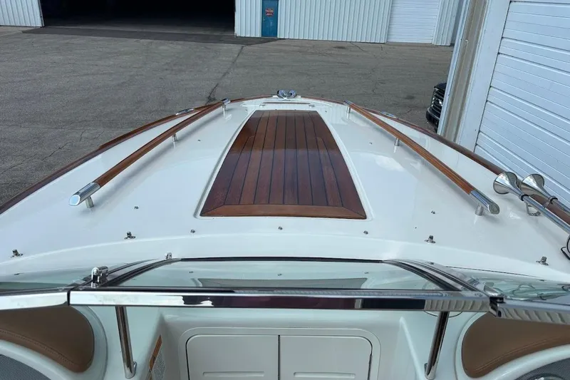 Slide: The Image of 2007 Chris-Craft Corsair 25 boat with sleek wooden deck and chrome accents. - 9
