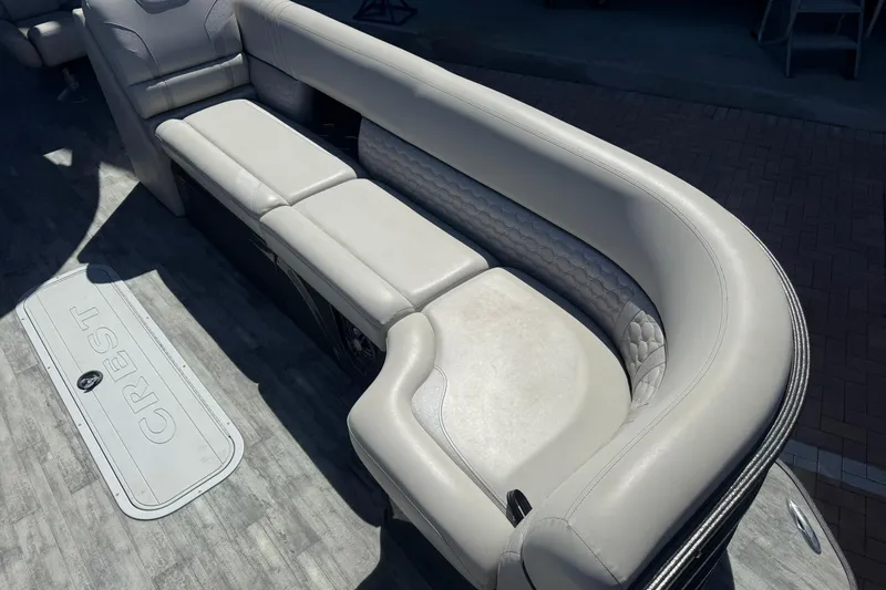 Slide: The Image of Luxurious seating on 2021 Crest Caribbean Platinum 250 SLC pontoon boat, featuring elegant upholstery. - 10