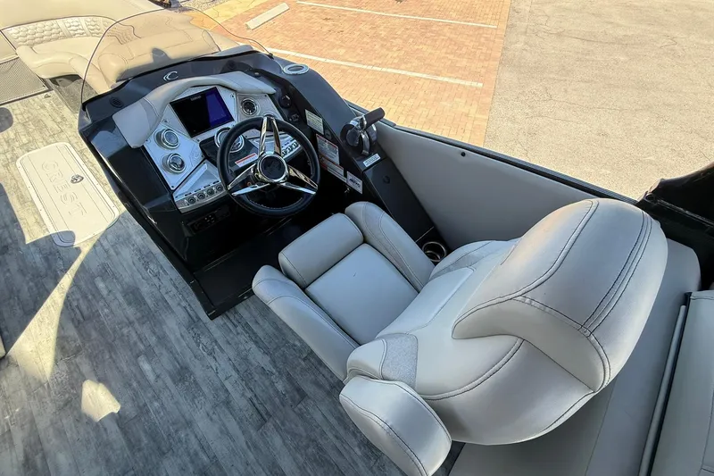 Slide: The Image of Captain's helm of 2021 Crest Caribbean Platinum 250 SLC with modern controls and seating. - 17