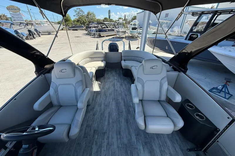 Slide: The Image of 2021 Crest Caribbean Platinum 250 SLC pontoon boat interior with luxurious seating and modern design. - 19