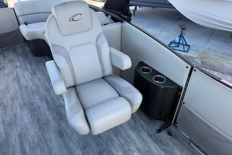 Slide: The Image of Luxury seating on 2021 Crest Caribbean Platinum 250 SLC pontoon boat, featuring cup holders. - 20