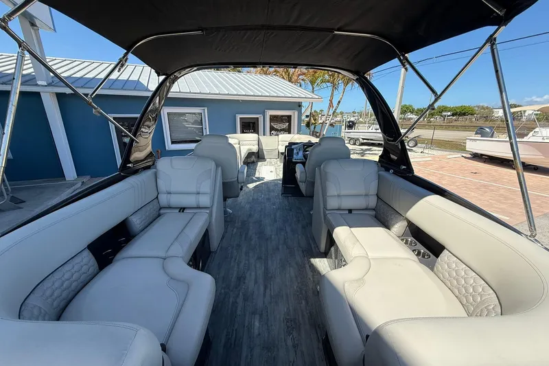 Slide: The Image of 2021 Crest Caribbean Platinum 250 SLC pontoon boat with luxurious seating and canopy. - 26