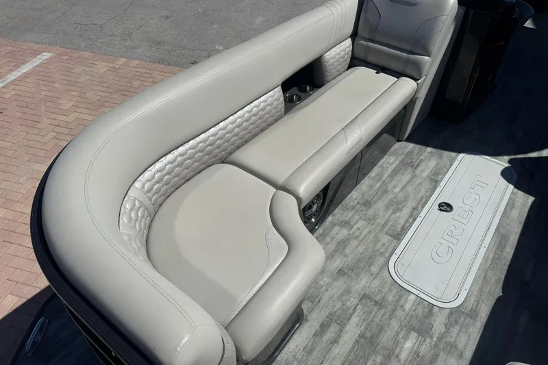 Slide: The Image of Luxurious seating on 2021 Crest Caribbean Platinum 250 SLC pontoon boat, featuring elegant design. - 9