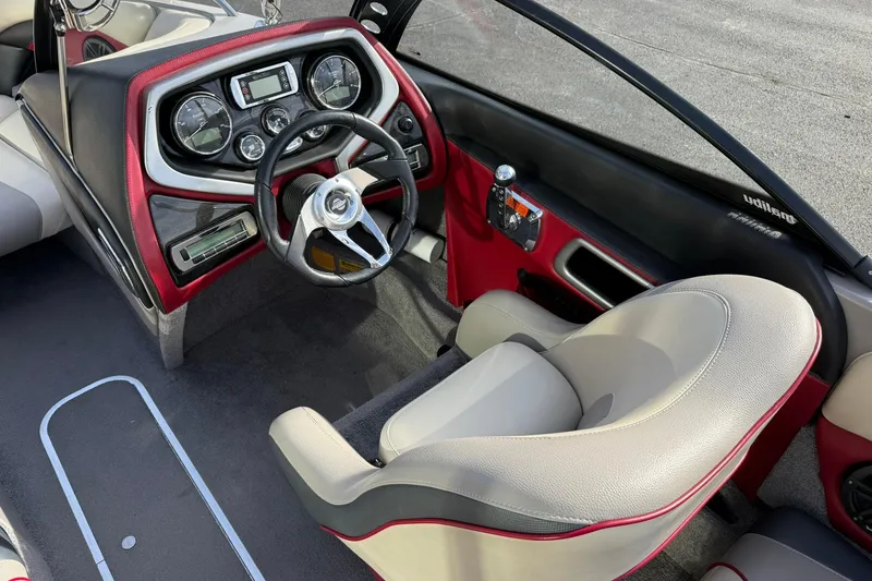 Slide: The Image of 2008 Malibu Sunscape 23 LSV boat interior with steering wheel and dashboard controls. - 11