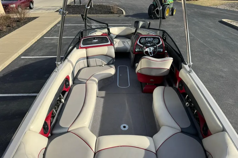 Slide: The Image of 2008 Malibu Sunscape 23 LSV boat interior with spacious seating and modern dashboard. - 13
