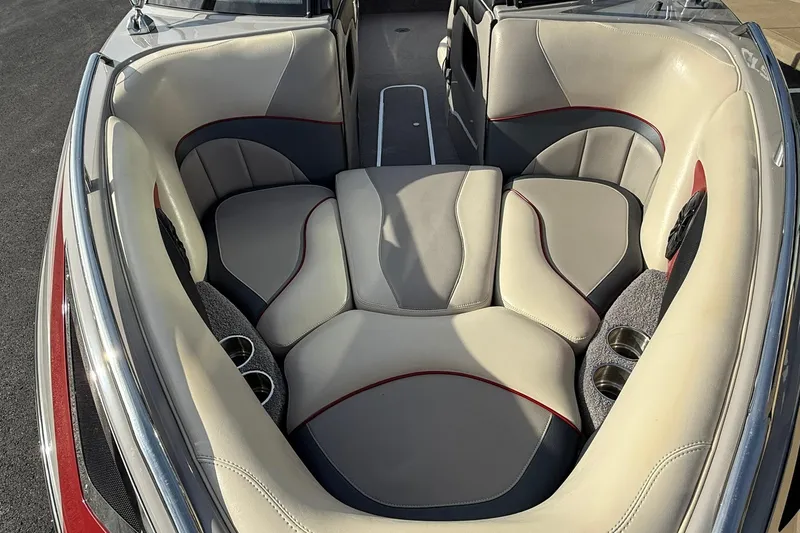 Slide: The Image of 2008 Malibu Sunscape 23 LSV boat interior with beige and red-trimmed seating. - 15