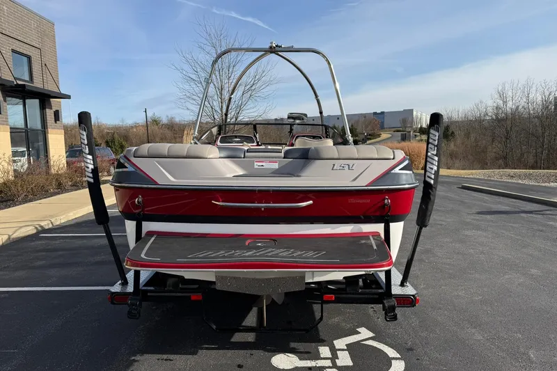 Slide: The Image of 2008 Malibu Sunscape 23 LSV boat, rear view, parked outdoors on a sunny day. - 4
