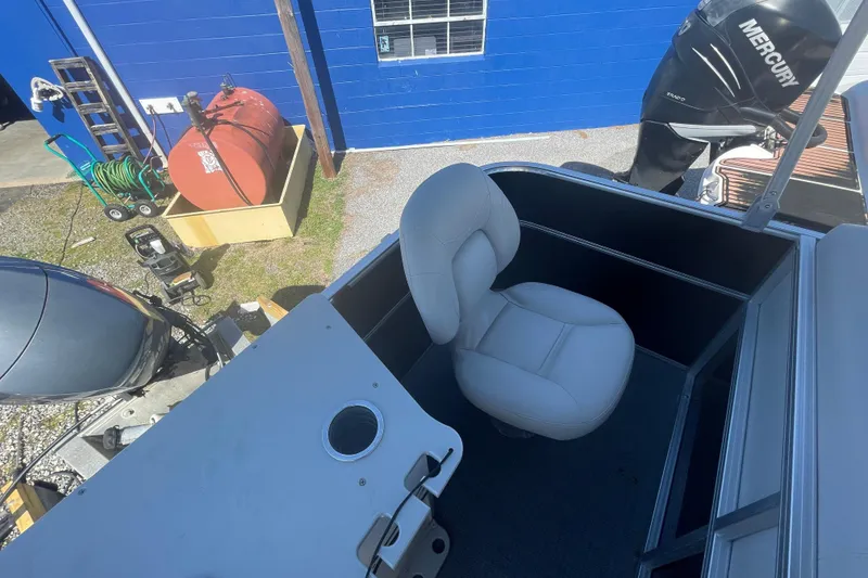 Slide: The Image of 2016 Starcraft EX 20 CF boat interior with seating and Mercury engine. - 11