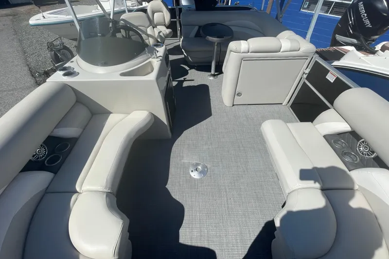 Slide: The Image of 2016 Starcraft EX 20 CF pontoon boat interior with plush seating and modern dashboard. - 14