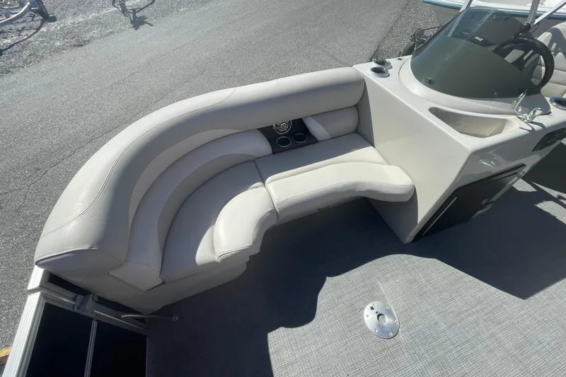 Slide: The Image of 2016 Starcraft EX 20 CF boat interior with curved seating and steering console. - 16