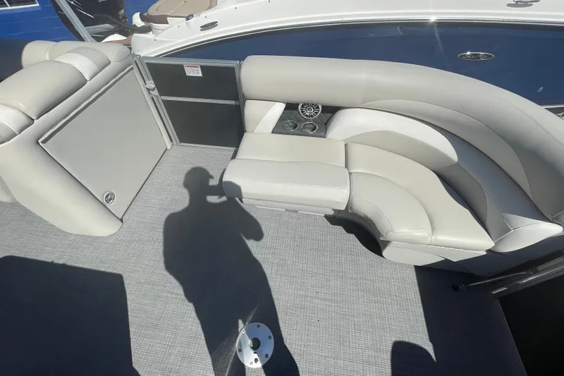 Slide: The Image of 2016 Starcraft EX 20 CF boat interior with gray seating and carpet flooring. - 18
