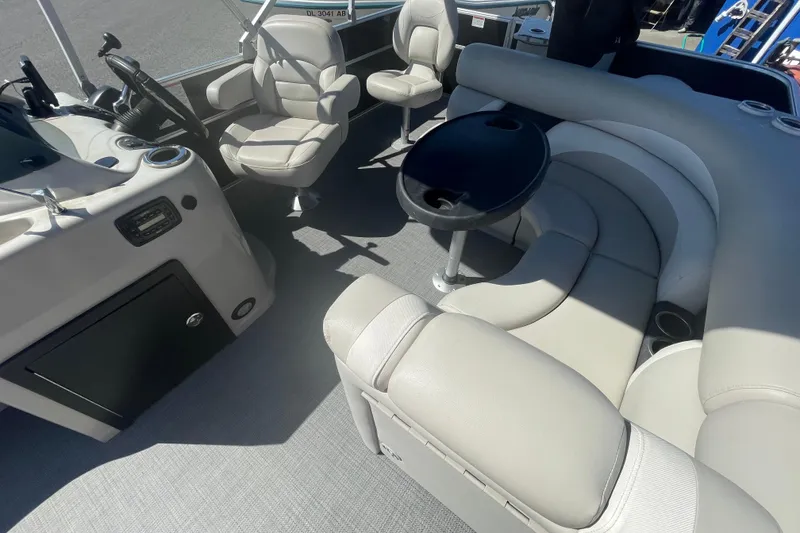 Slide: The Image of 2016 Starcraft EX 20 CF boat interior with plush seating and steering console. - 19