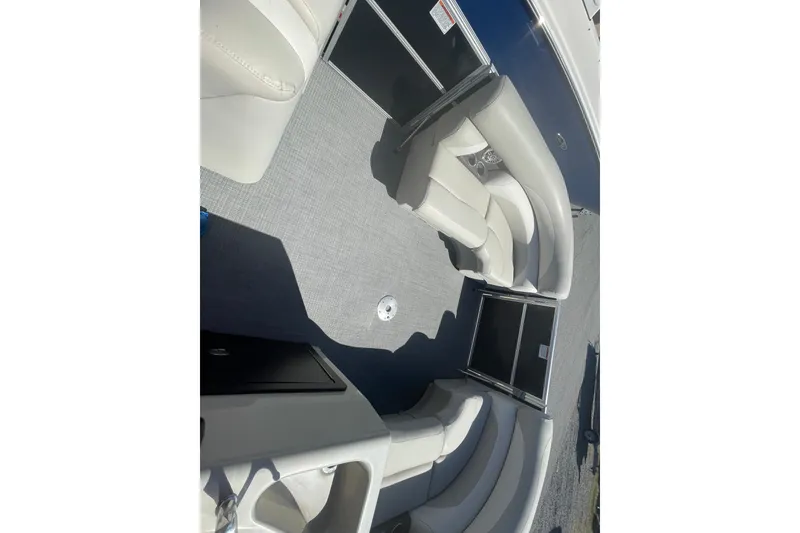 Slide: The Image of 2016 Starcraft EX 20 CF pontoon boat interior with plush seating and spacious layout. - 2
