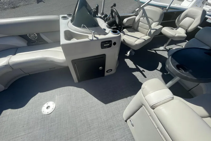 Slide: The Image of Interior of a 2016 Starcraft EX 20 CF boat with seating and steering console. - 20