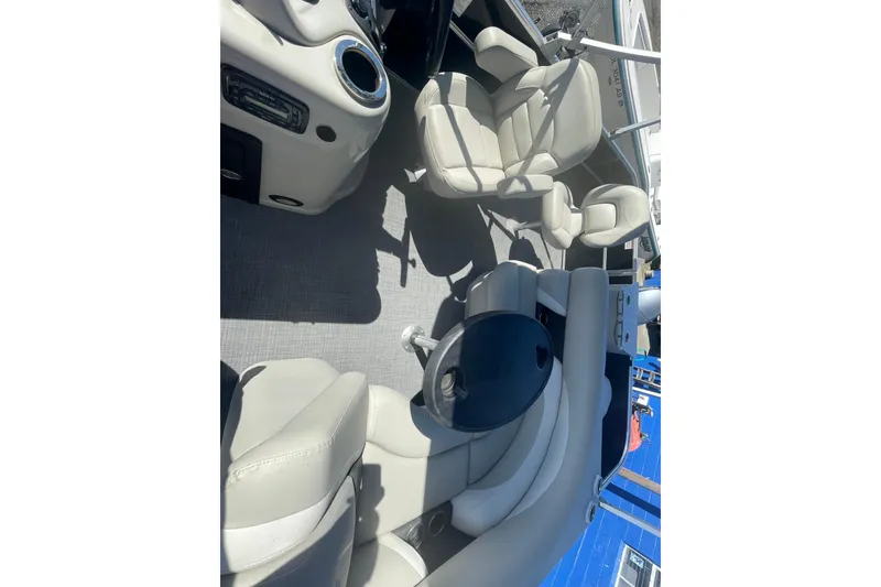 Slide: The Image of 2016 Starcraft EX 20 CF boat interior with beige seating and control panel. - 3