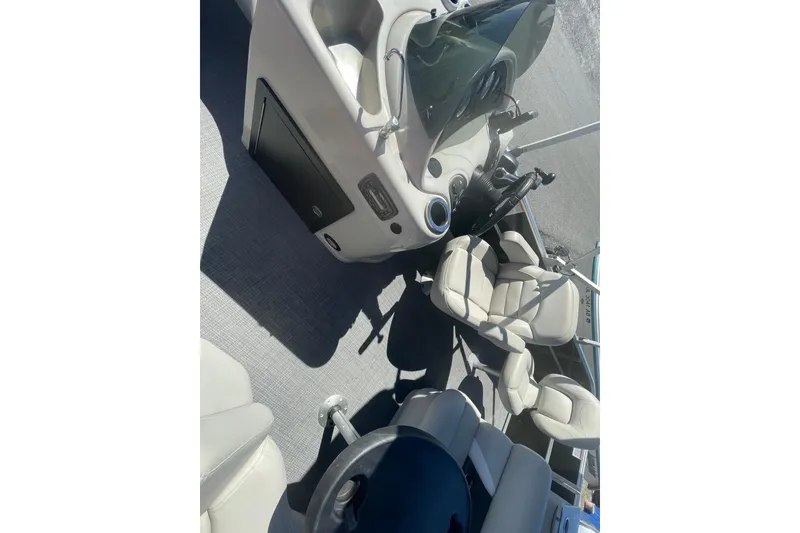 Slide: The Image of Interior of 2016 Starcraft EX 20 CF boat with beige seating and steering console. - 4