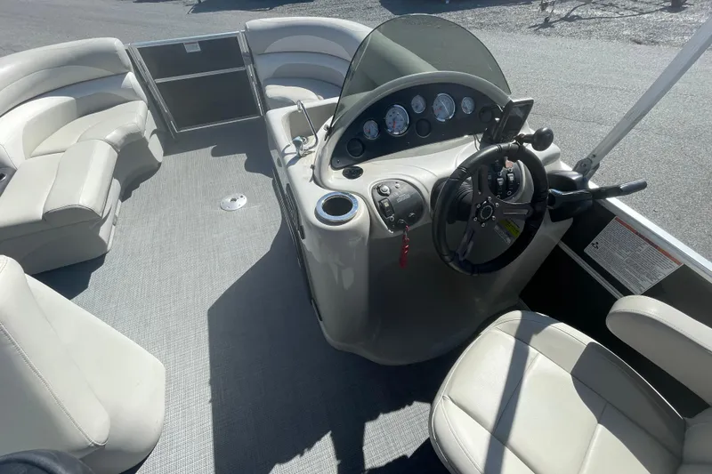 Slide: The Image of 2016 Starcraft EX 20 CF boat interior with steering console and seating. - 5