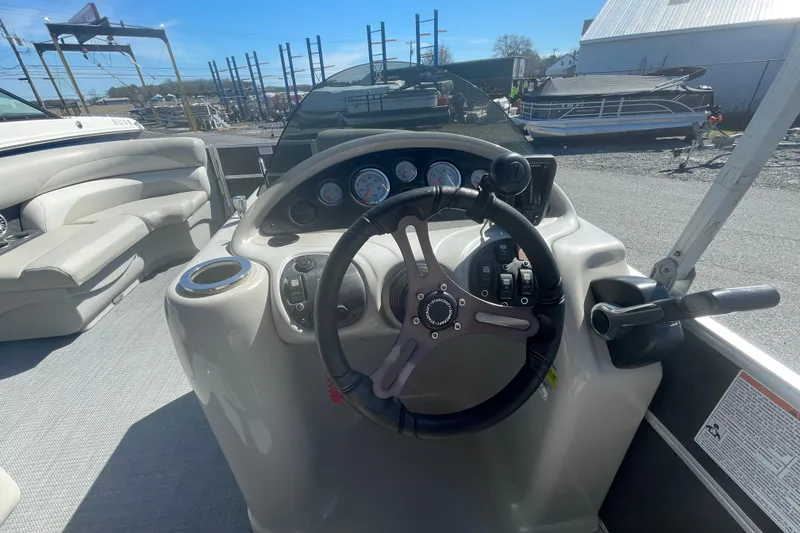 Slide: The Image of 2016 Starcraft EX 20 CF boat dashboard with steering wheel and controls. - 6