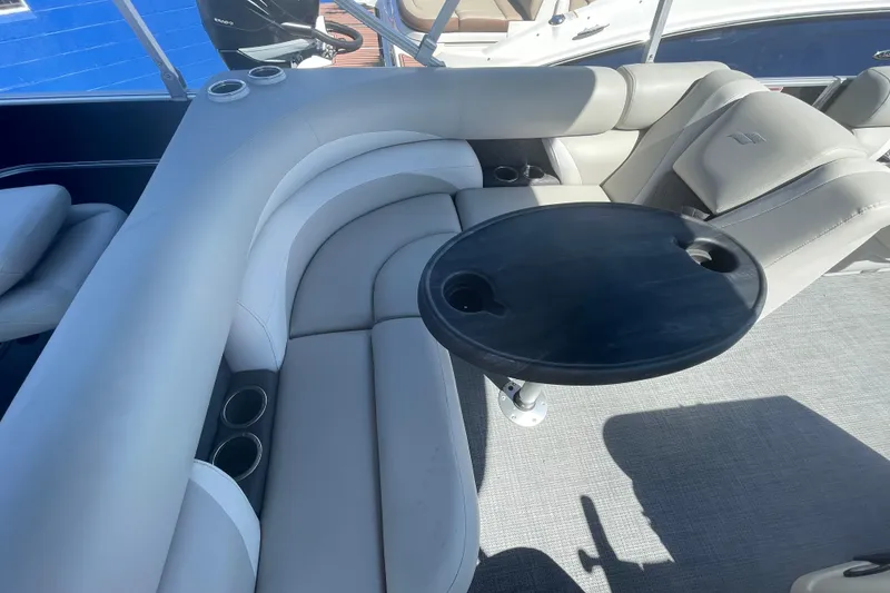 Slide: The Image of 2016 Starcraft EX 20 CF boat interior with gray seating and a round black table. - 7