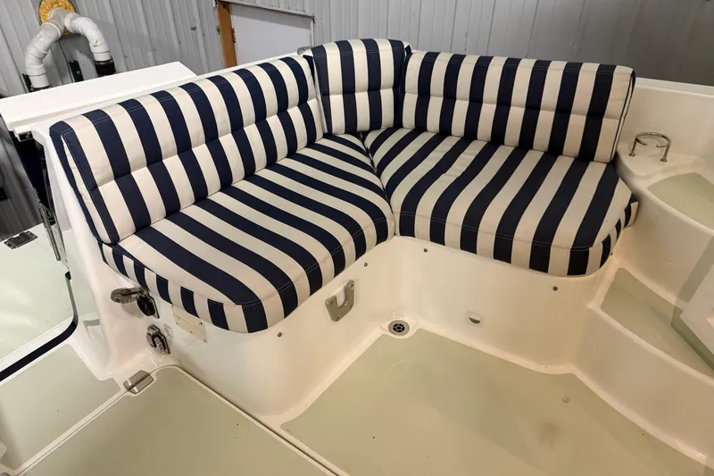 Slide: The Image of Striped seating on 2017 Back Cove 37 boat, featuring navy and white cushions. - 14
