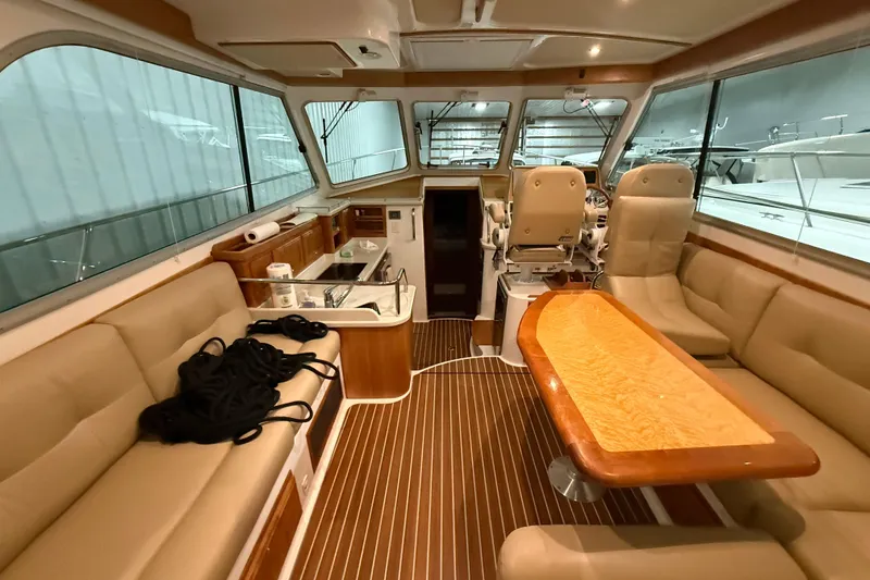 Slide: The Image of Interior of a 2017 Back Cove 37 yacht with beige seating and wooden accents. - 16