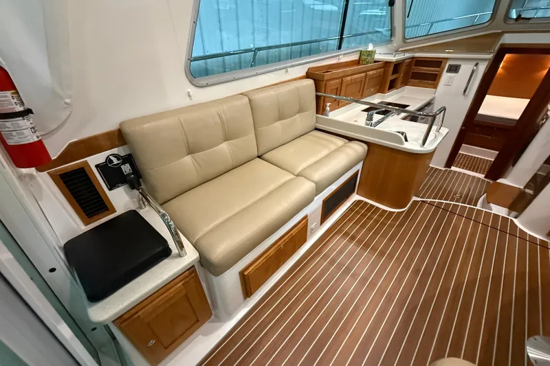 Slide: The Image of Interior of 2017 Back Cove 37 yacht with beige seating and wooden cabinetry. - 17
