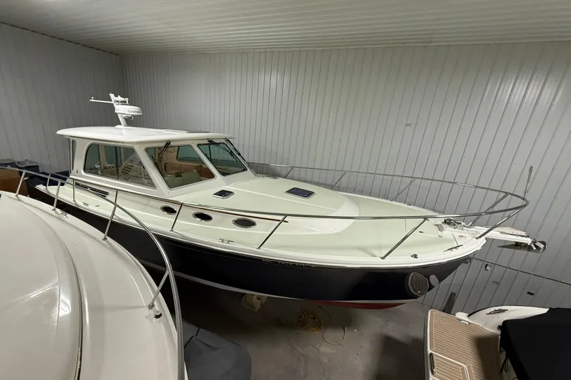 Slide: The Image of 2017 Back Cove 37 boat in storage, featuring sleek design and enclosed cabin. - 2