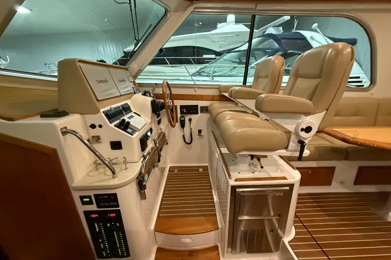 Slide: The Image of 2017 Back Cove 37 yacht interior with helm, leather seats, and navigation equipment. - 22