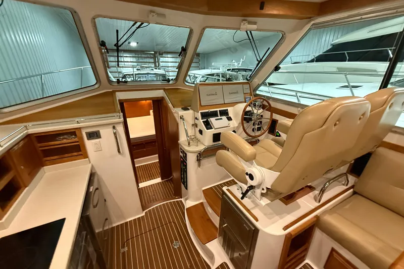 Slide: The Image of Interior of 2017 Back Cove 37 yacht with helm, seating, and navigation equipment. - 23