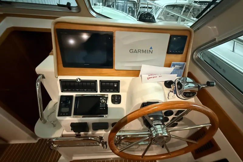 Slide: The Image of Helm of 2017 Back Cove 37 with Garmin navigation and wooden steering wheel. - 26