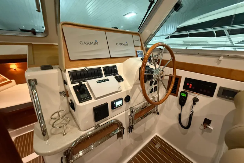 Slide: The Image of Helm of 2017 Back Cove 37 boat with Garmin navigation system and wooden steering wheel. - 27