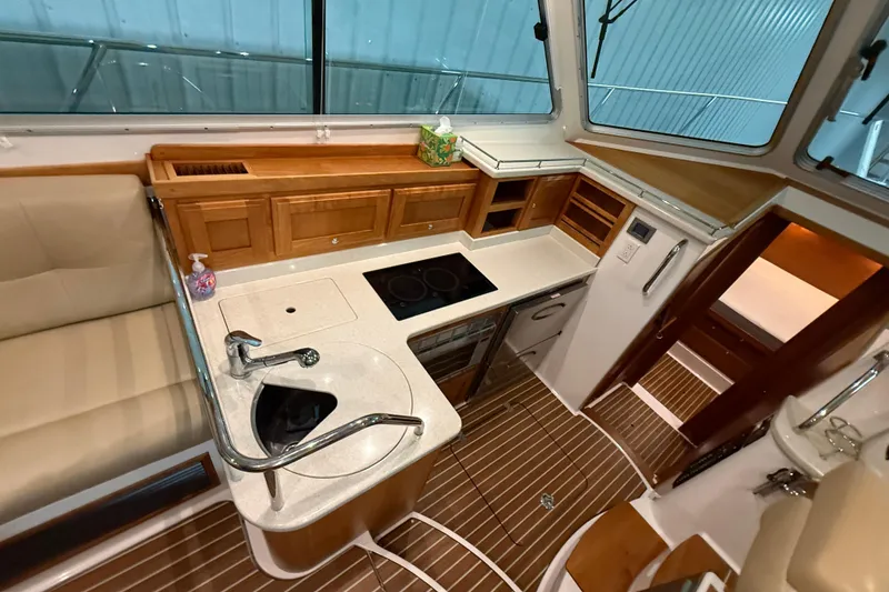 Slide: The Image of Interior of 2017 Back Cove 37 yacht featuring modern kitchen and wooden cabinetry. - 29