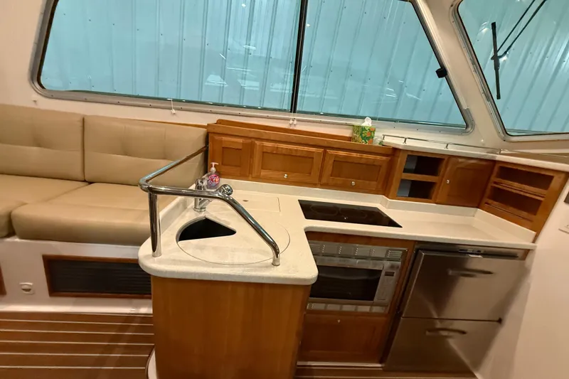 Slide: The Image of Interior of 2017 Back Cove 37 yacht featuring modern kitchen and seating area. - 31