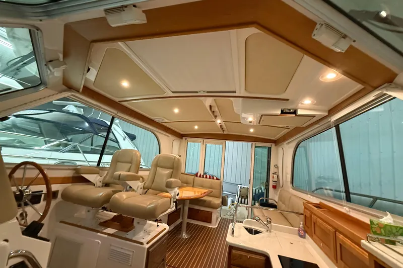 Slide: The Image of Interior of 2017 Back Cove 37 yacht with seating, helm, and kitchenette. - 33