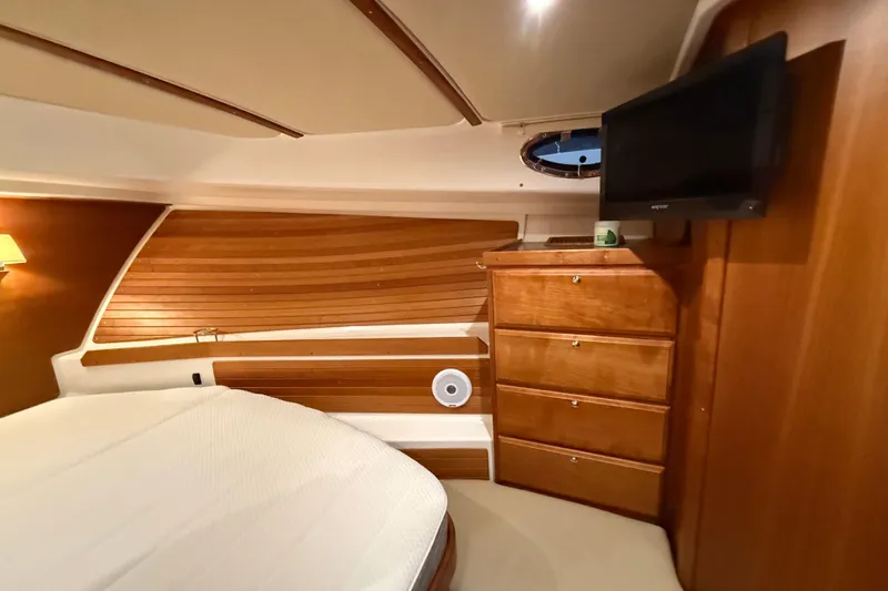 Slide: The Image of Luxurious cabin interior of a 2017 Back Cove 37 yacht with wood paneling and TV. - 37