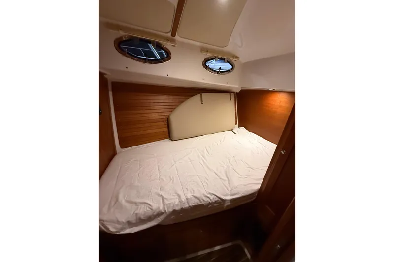 Slide: The Image of Cozy cabin interior of 2017 Back Cove 37 yacht with wooden accents and porthole windows. - 38