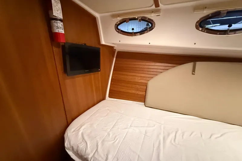 Slide: The Image of Cozy cabin interior of 2017 Back Cove 37 yacht with bed, TV, and portholes. - 39