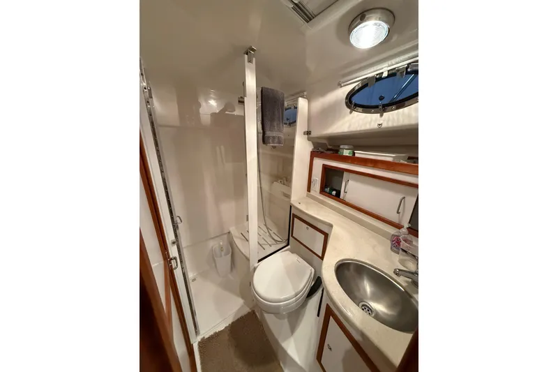 Slide: The Image of 2017 Back Cove 37 yacht bathroom with shower, sink, and storage cabinets. - 43