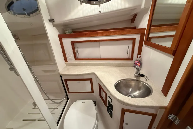 Slide: The Image of 2017 Back Cove 37 yacht bathroom with sink, toilet, and shower area. - 46