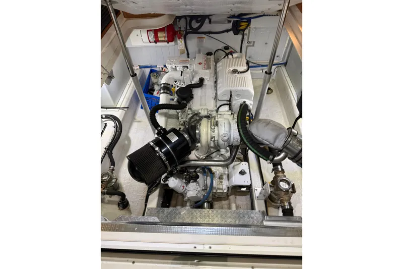 Slide: The Image of Engine compartment of a 2017 Back Cove 37 boat, showcasing mechanical components. - 47