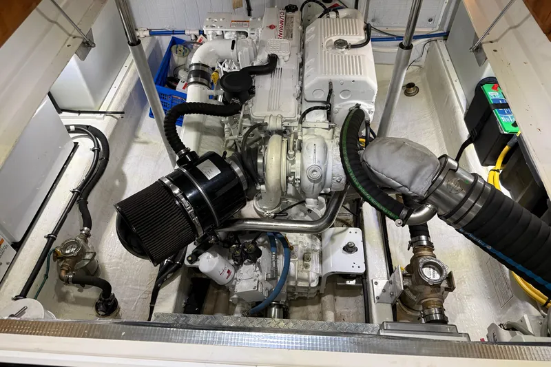 Slide: The Image of Engine compartment of a 2017 Back Cove 37 boat, showcasing mechanical components and wiring. - 48