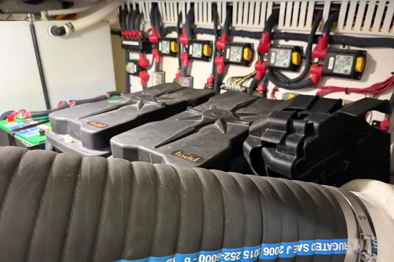 Slide: The Image of Engine room of a 2017 Back Cove 37 boat, featuring batteries and electrical components. - 50