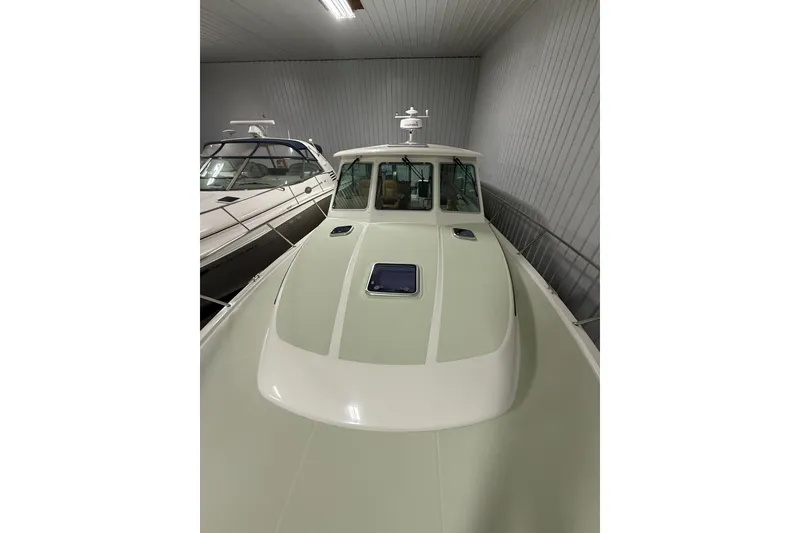 Slide: The Image of 2017 Back Cove 37 boat in storage, showcasing sleek design and spacious deck. - 6