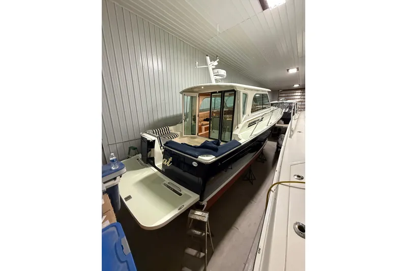 Slide: The Image of 2017 Back Cove 37 yacht in indoor storage, showcasing sleek design and spacious deck. - 7