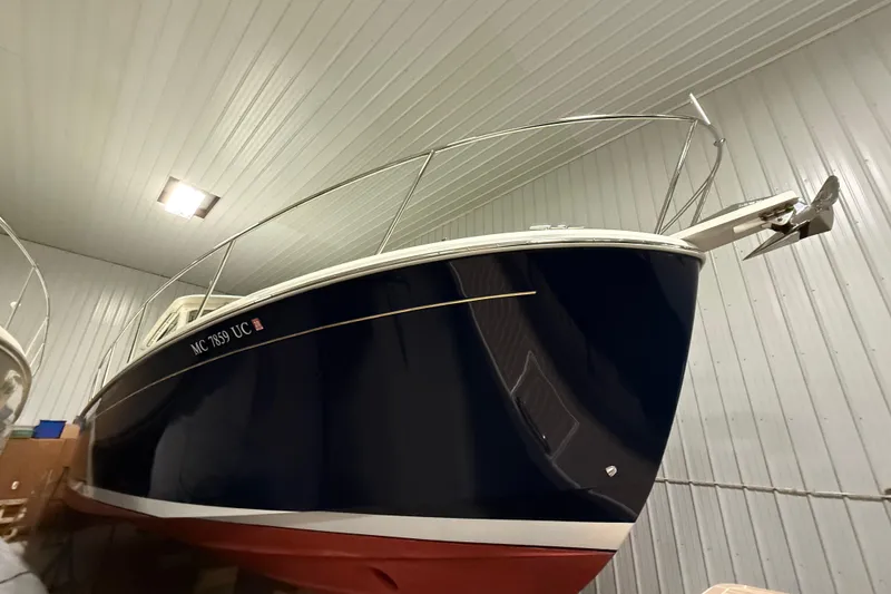 Slide: The Image of 2017 Back Cove 37 boat in indoor storage, showcasing sleek design and navy blue hull. - 9