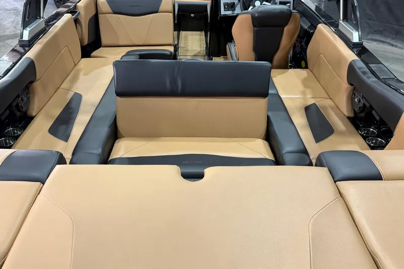 Slide: The Image of 2022 MasterCraft NXT24 boat interior with tan and black seating, showcasing luxury design. - 6